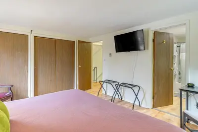 a bedroom with a bed and a tv on a wall at Upstate Winter Escape! 2 Mi to GlobalFoundries in Malta