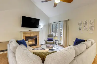a living room with a couch and a fireplace at Upstate Winter Escape! 2 Mi to GlobalFoundries in Malta