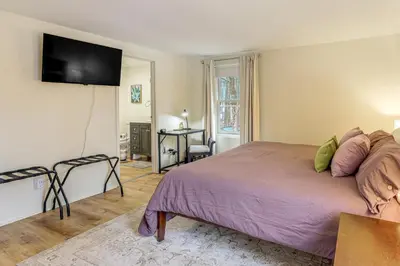 a bedroom with a bed and a television on the wall at Upstate Winter Escape! 2 Mi to GlobalFoundries in Malta