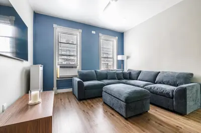 a living room with a couch and a tv at Ultimate Urban living at Centrally Located Apartments in New York