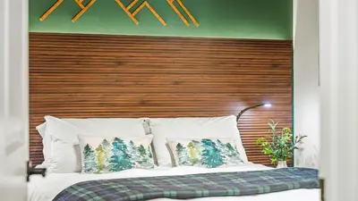 a bedroom with a bed with a wooden headboard at Hot Tub Lake Access Community Amenities Somerset Lodge by AvantStay in East Stroudsburg
