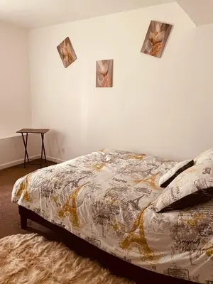 a bed in a room with four pictures on the wall at Angelica peaceful place in West Haven