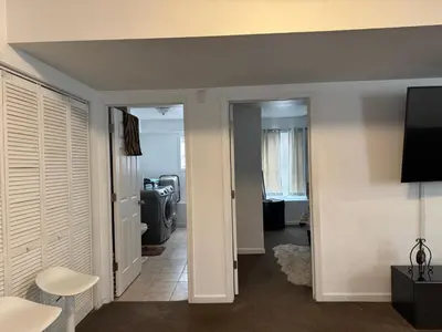 a hallway with a living room with a television and a room at Angelica peaceful place in West Haven