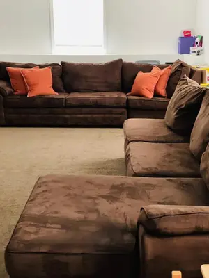 a living room with a brown couch with orange pillows at Angelica peaceful place in West Haven