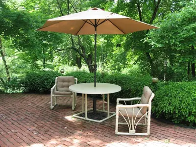 a table with two chairs and an umbrella at Omega Special, Sun thru thurs 5 night minimum in Clinton Corners