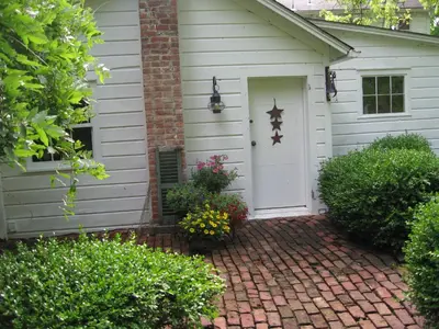 a house with a white door and a brick driveway at Omega Special, Sun thru thurs 5 night minimum in Clinton Corners