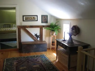a living room with a wooden door in a room at Omega Special, Sun thru thurs 5 night minimum in Clinton Corners