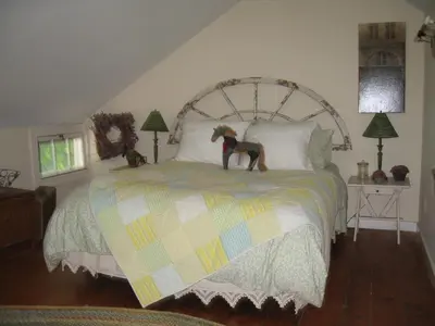 a dog statue on a bed in a bedroom at Omega Special, Sun thru thurs 5 night minimum in Clinton Corners