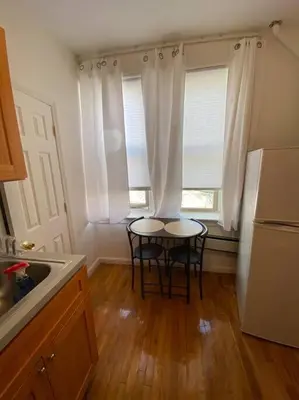 a kitchen with a table and two chairs in it at Apart Studio West NY 12Mints From NYCIty Times Square in West New York