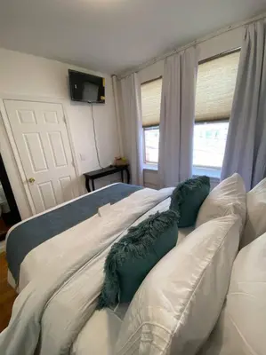 a bedroom with two white pillows on a bed at Apart Studio West NY 12Mints From NYCIty Times Square in West New York