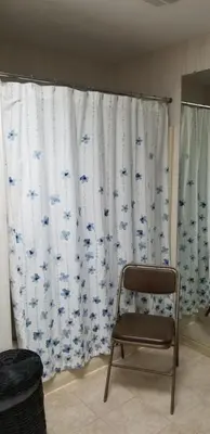 a chair sitting in front of a curtain with blue birds at Mountain Lake Retreat in Clifton