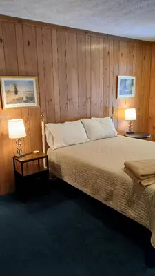 a bedroom with a large bed and two lamps at Mountain Lake Retreat in Clifton