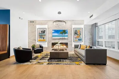 a living room with two couches and a fireplace at Jersey City's Best Enjoy Our Deluxe 1 Bedroom Condo Only 25 Minutes to NYC in Jersey City