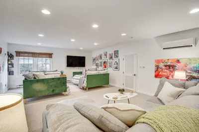 a living room with a couch and a tv at Serene Holmes Cottage Near Lakes and Trails! in Pawling