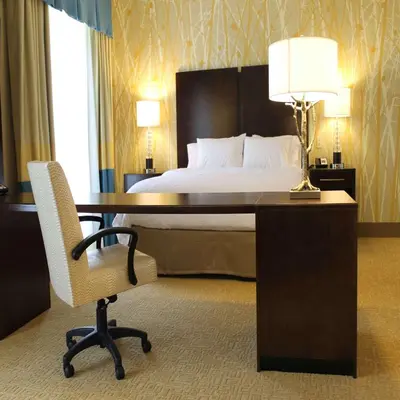 a bedroom with a bed and a desk with a chair at Hampton Inn & Suites Stroudsburg Bartonsville Poconos in Stroudsburg