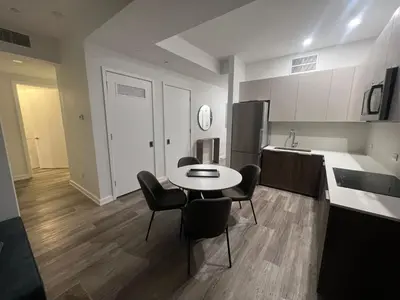 a kitchen with a table and chairs in a room at Luxury 2 BD unit in Financial District in New York