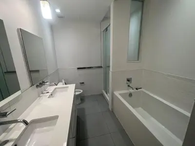 a bathroom with two sinks and a tub and a toilet at Luxury 2 BD unit in Financial District in New York