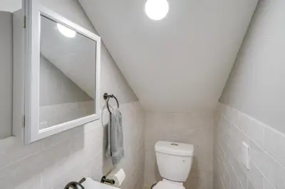 a bathroom with a white toilet and a sink at 2 Mi to Windham Mountain Scenic Home with Fire Pit! in Windham