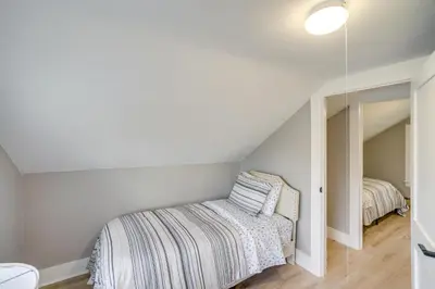 a bedroom with a bed and a mirror at 2 Mi to Windham Mountain Scenic Home with Fire Pit! in Windham