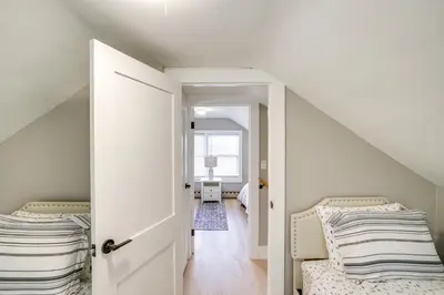 a bedroom with two beds and an open door at 2 Mi to Windham Mountain Scenic Home with Fire Pit! in Windham