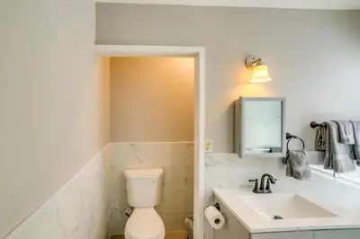 a bathroom with a toilet and a sink at 2 Mi to Windham Mountain Scenic Home with Fire Pit! in Windham