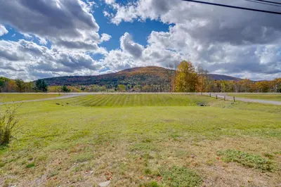 an open field with a mountain in the background at 2 Mi to Windham Mountain Scenic Home with Fire Pit! in Windham