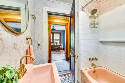a bathroom with a pink sink and a tub at Pet-Friendly Catskills Retreat Fire Pit and Deck! in Grand Gorge
