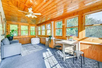 a home office with a ceiling fan and a desk at Pet-Friendly Catskills Retreat Fire Pit and Deck! in Grand Gorge