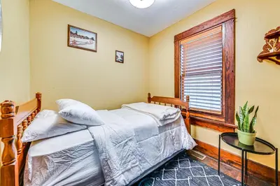 a bedroom with a bed and a table and a window at Pet-Friendly Catskills Retreat Fire Pit and Deck! in Grand Gorge