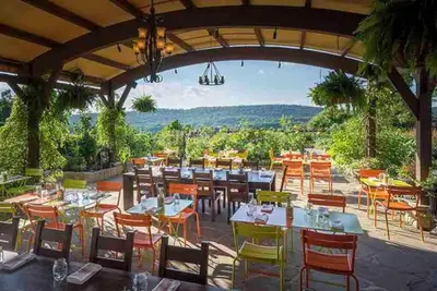a restaurant with tables and chairs with a view at Luxe 10 guest Cottage Ski-Golf-Firepit-Lakes-Hike in Vernon Township