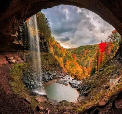 a view of a waterfall from a cave with a waterfall at Unique Fully Restored Landmark Barn in Hudson in Claverack