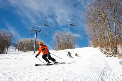 three people skiing down a snow covered ski lift at Unique Fully Restored Landmark Barn in Hudson in Claverack