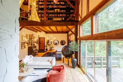 a living room with a couch and a table at Unique Fully Restored Landmark Barn in Hudson in Claverack
