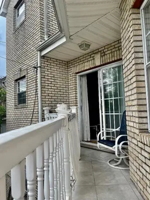 a porch with a white railing on a house at 4 bedroom apt in Newark in Newark