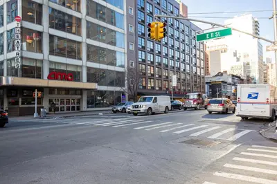 a busy city street with cars and a traffic light at E Village 1BR w Doorman Gym nr Union Sq NYC-10 in New York