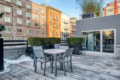 a patio with a table and chairs on a balcony at E Village 1BR w Doorman Gym nr Union Sq NYC-10 in New York
