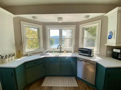 a kitchen with a sink and two windows at Upper Delaware River House in Equinunk