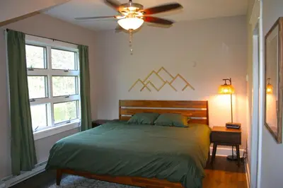 a bedroom with a bed and a ceiling fan at Upper Delaware River House in Equinunk