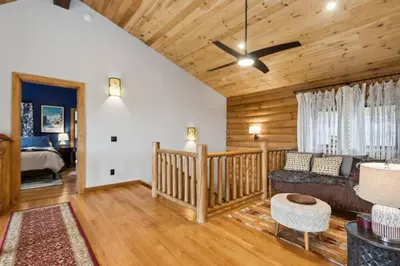 a living room with a couch and a ceiling fan at Snow Nirvana in Hunter