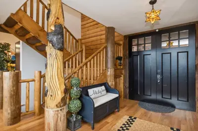 a living room with a staircase and a blue couch at Snow Nirvana in Hunter