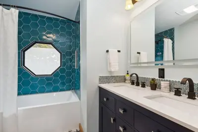 a bathroom with a tub and a sink and a mirror at Snow Nirvana in Hunter