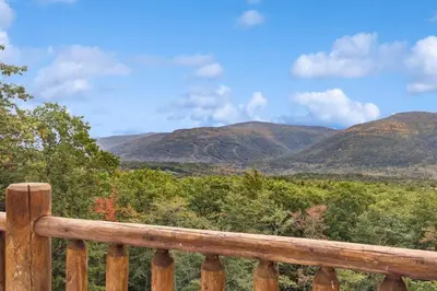 a view of mountains from a wooden railing at Snow Nirvana in Hunter