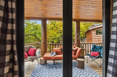 a porch with a couch and chairs on a deck at Snow Nirvana in Hunter