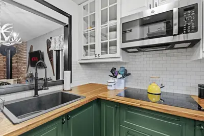 a kitchen with green cabinets and a sink at Mt Snow Retreat - Walk to brewery in Dover