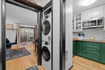 a kitchen with green cabinets and a washer and dryer at Mt Snow Retreat - Walk to brewery in Dover
