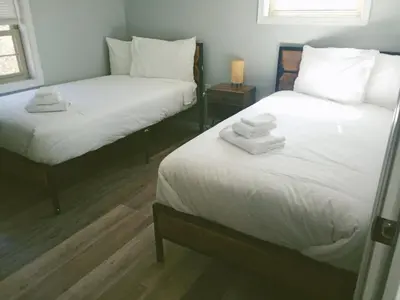 two beds in a room with towels on them at Cabin near kalahari,camelback Ski in Long Pond