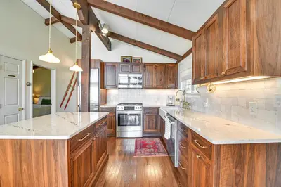 a kitchen with wooden cabinets and a stove top oven at Cozy Mtn-View Chalet Less Than 2 Mi to Windham Slopes in Windham