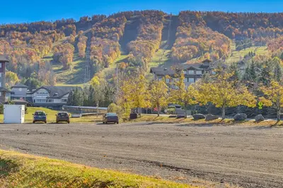 two cars parked on a dirt road in front of a mountain at Cozy Mtn-View Chalet Less Than 2 Mi to Windham Slopes in Windham