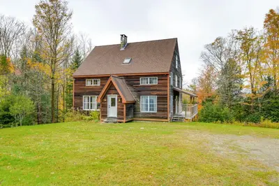 a wooden house on a grassy field with trees at Home 15 Mi to Berkshire East and Mount Snow! in Whitingham
