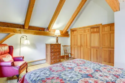 a bedroom with a bed and a chair and a dresser at Home 15 Mi to Berkshire East and Mount Snow! in Whitingham